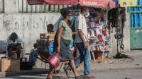 Des personnes portent un masque de protection contre le coronavirus dans une rue de Port-au-Prince, le 26 mars 2020 à Haïti [Pierre Michel Jean / AFP/Archives]